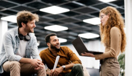 Portrait Of Coworkers Chatting In Modern Office