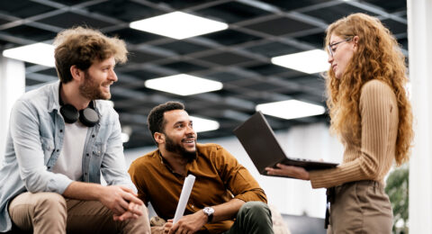Portrait Of Coworkers Chatting In Modern Office